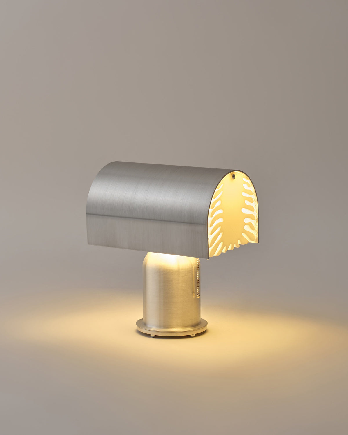 Bloom brushed steel table lamp with perforated shade by Hun Lee