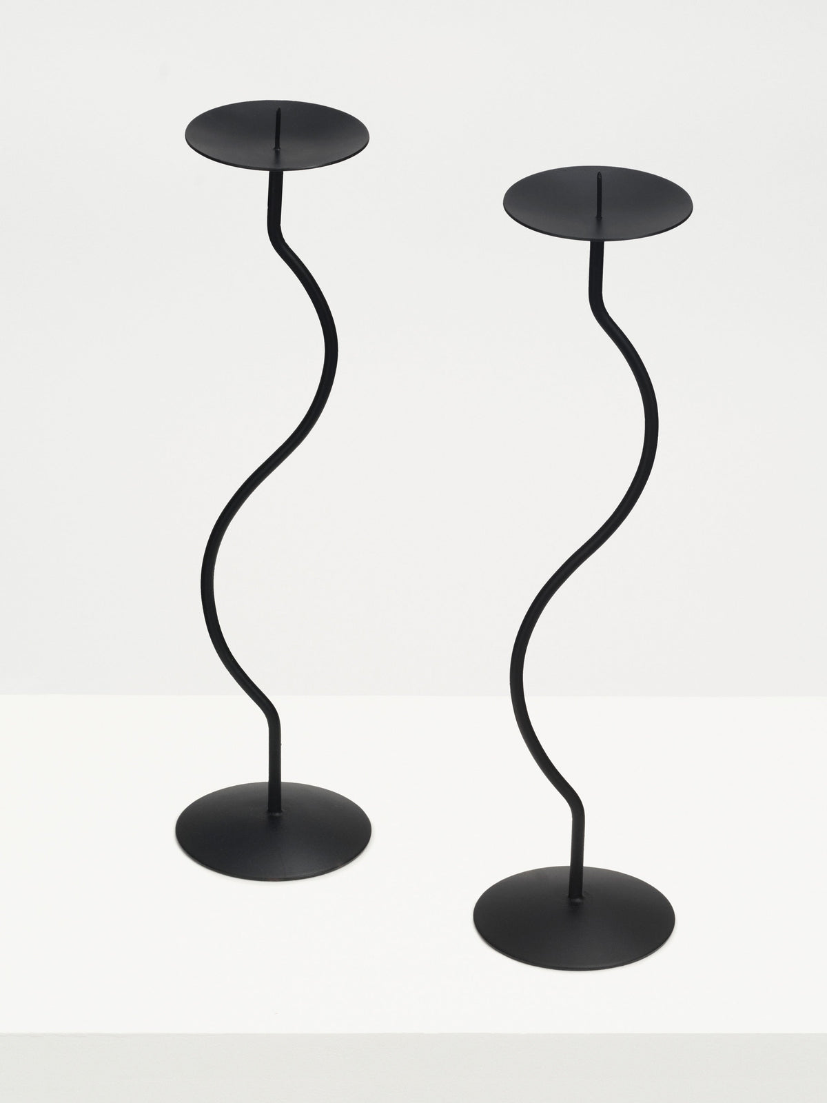 Two elegant iron sculptures of dancers, gracefully posed in a captivating dance routine, perfect for home decor