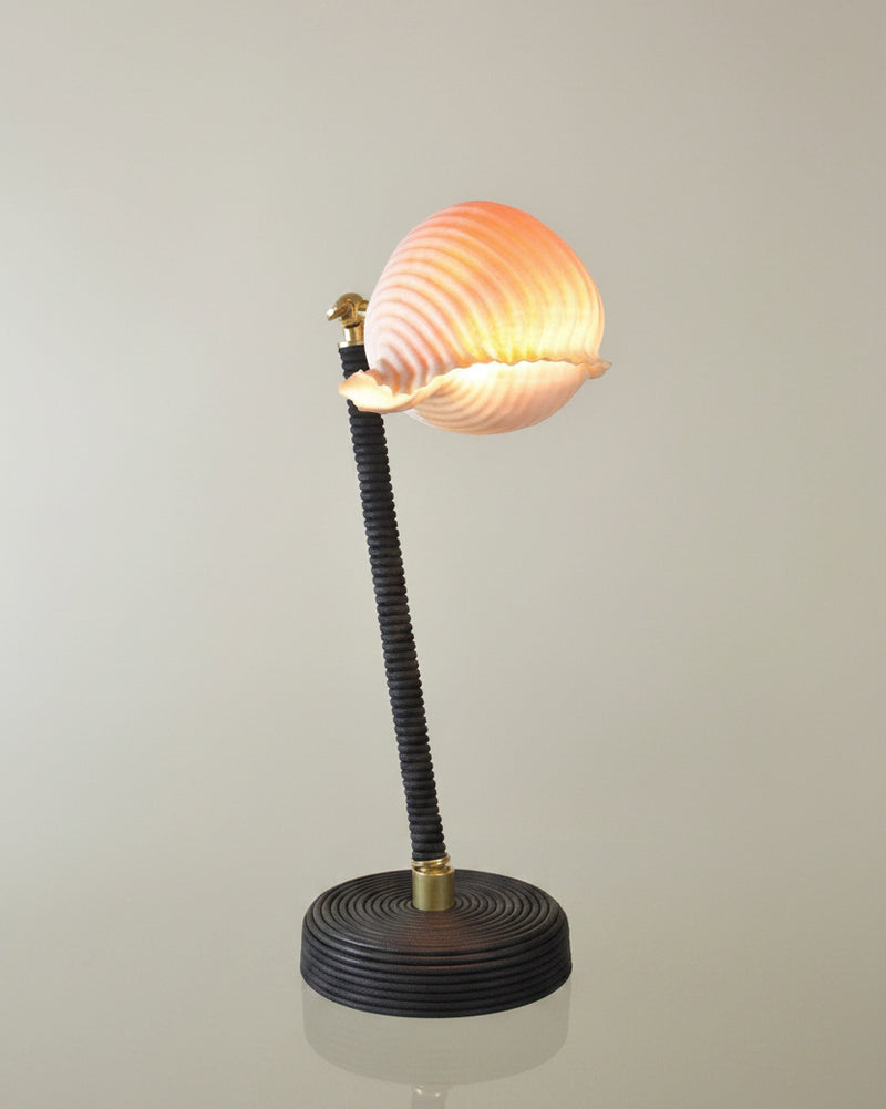 L'Escargot table lamp with ribbed glass shade on marble surface