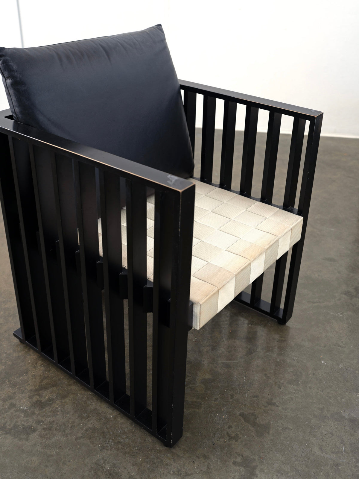Black metal frame Purkersdorf armchair with woven seat detail