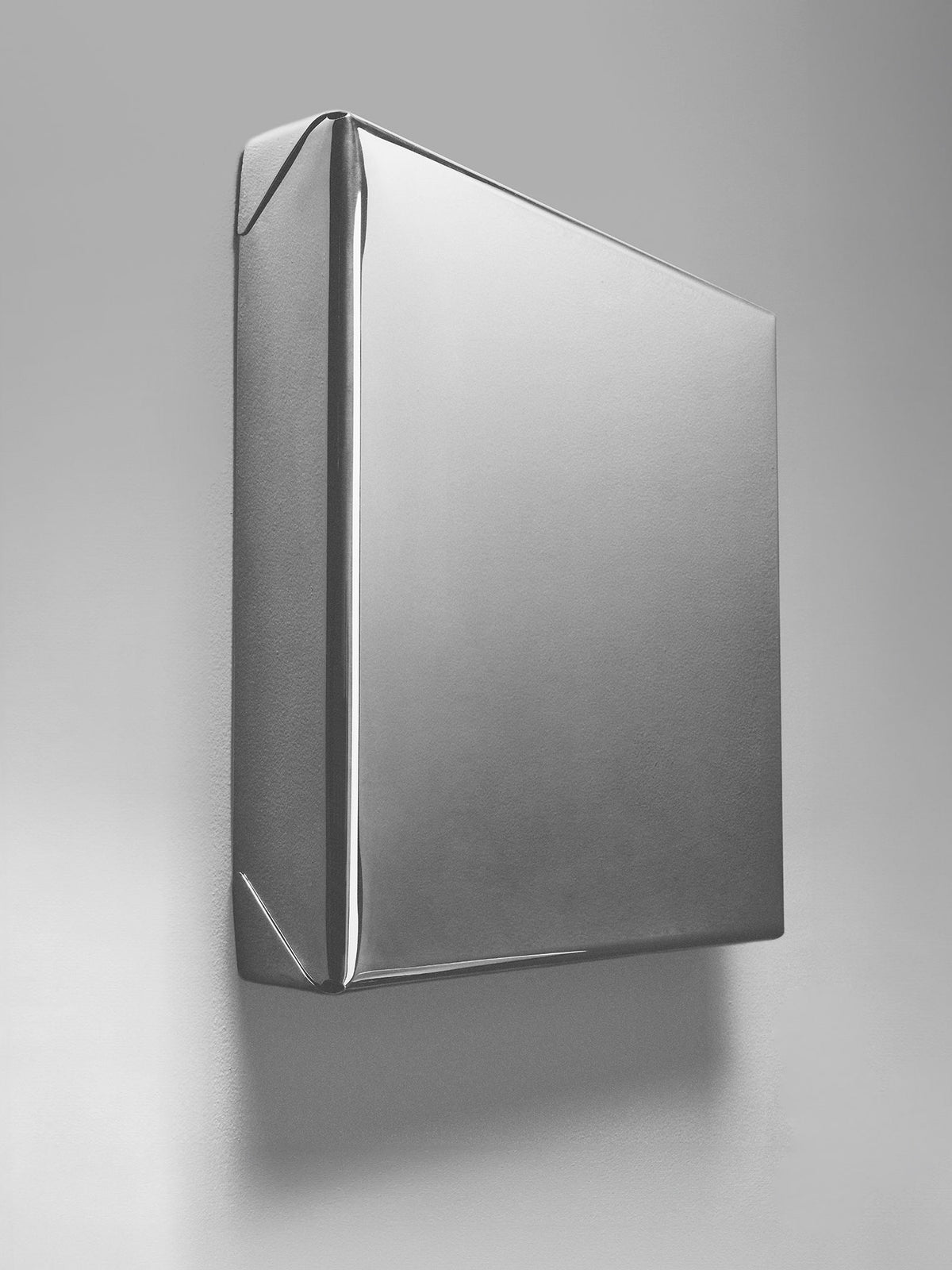 Modern geometric mirror with angular folded metal frame in silver finish