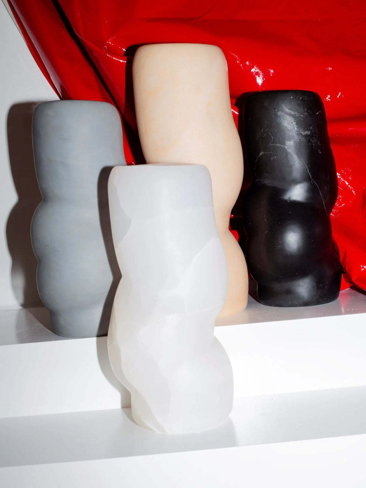 FATROLL White Onyx Vase in Marble — front view against red backdrop