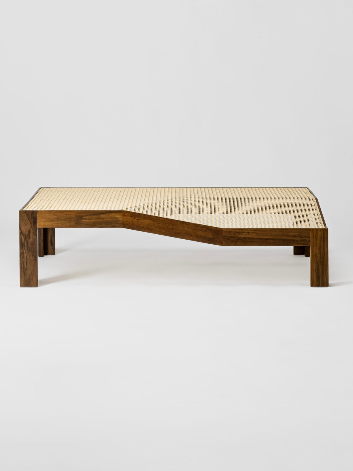 Modern wooden coffee table with woven cane top and curved design