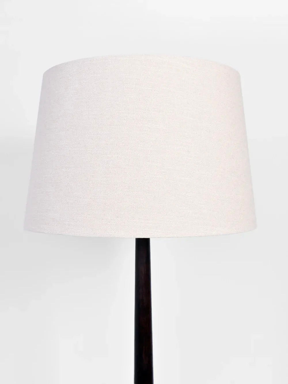 A product by Barracuda Interiors, the Dark Wooden Floor Lamp, 1930s features a minimalist design with a beige cylindrical lampshade and a sleek stand, evocative of 1930s French style, set against a plain white background.