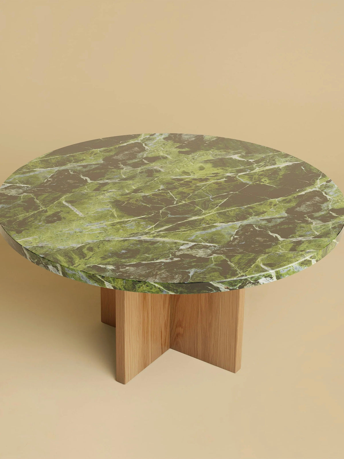 The beige background showcases the Lebanto "Tinian" Coffee Table, featuring a round green and brown marble top on an oak wood base with four intersecting legs.