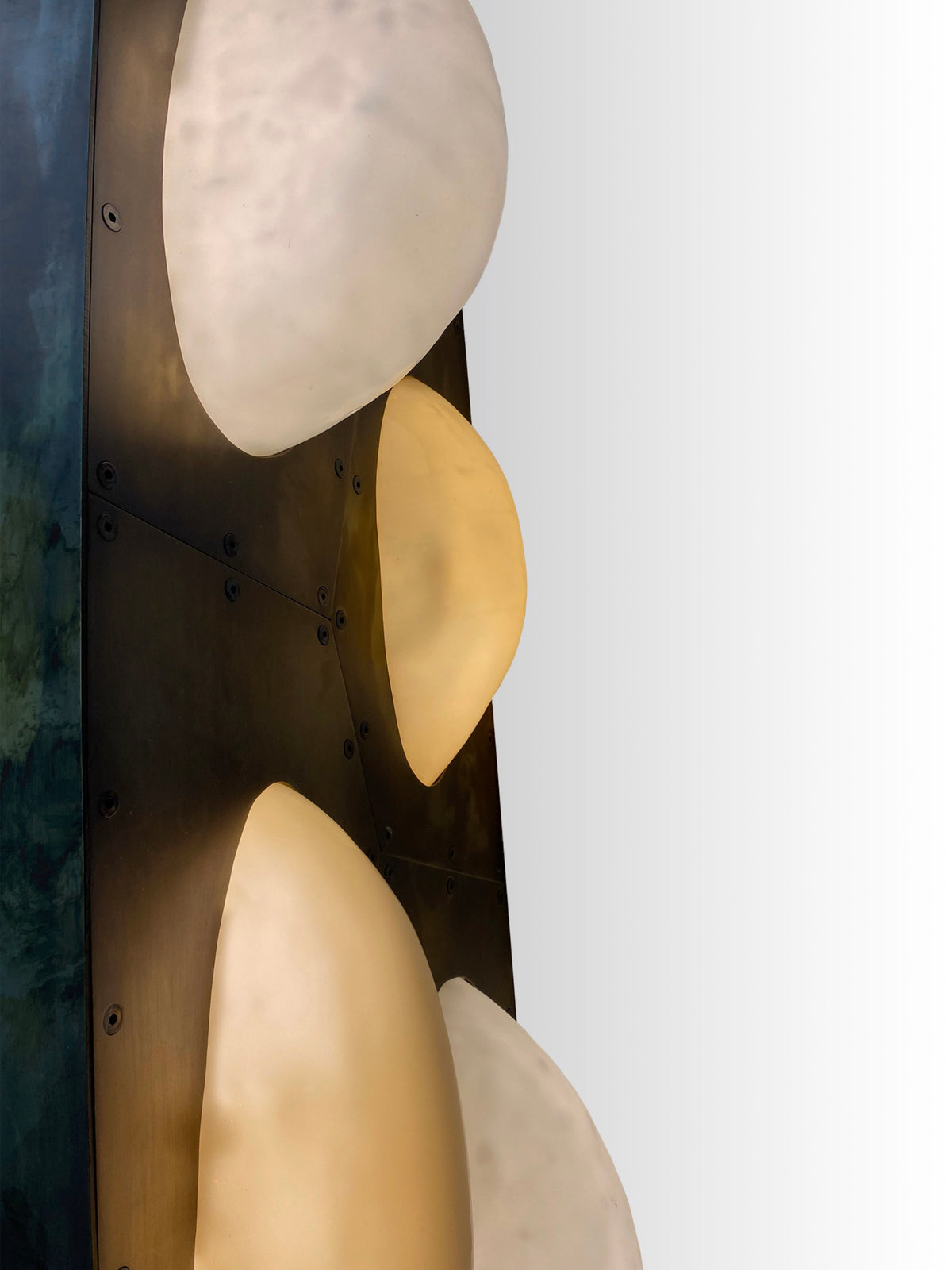 Curved brass fixture detail showing layered bubble glass pendant lights