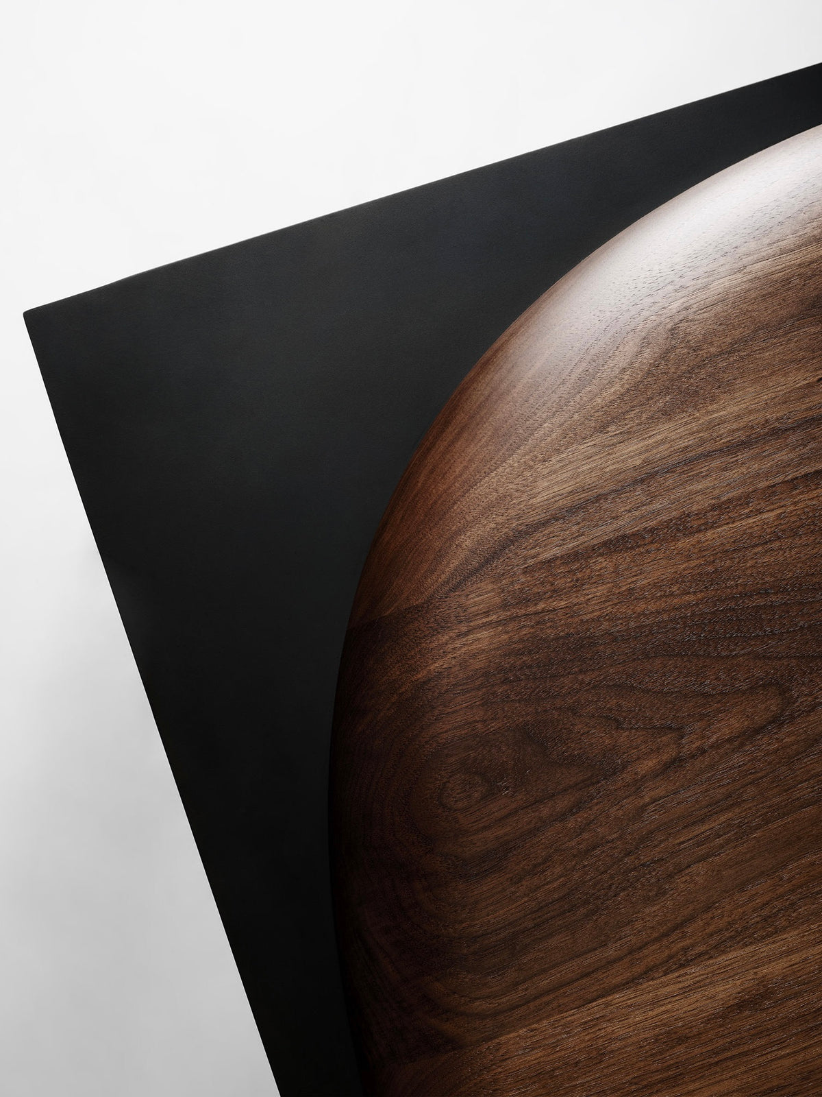 Split coffee table curved wood grain detail with black geometric element