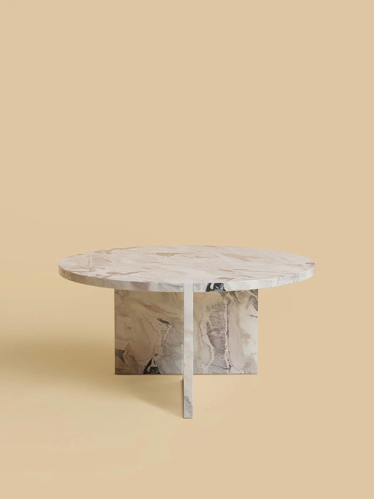 The "Hashi" Coffee Table by Lebanto, featuring a geometric base, stands against a beige background. Its marble top showcases a blend of cream, gray, and brown tones, highlighting its elegant and polished design.