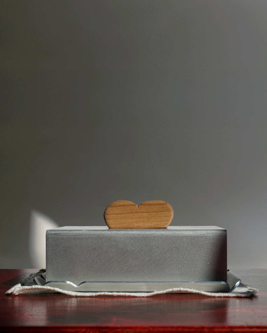 Modern stainless steel butter dish with wooden heart-shaped handle