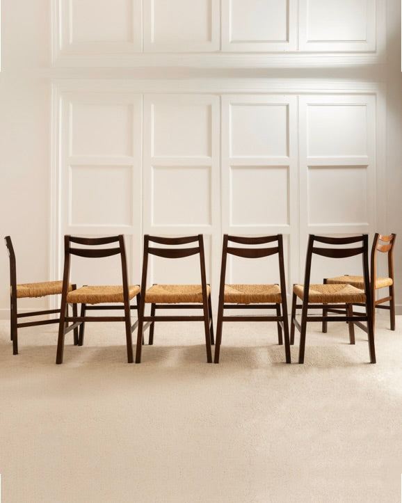Six 1960s Italian dining chairs with woven rush seats in row