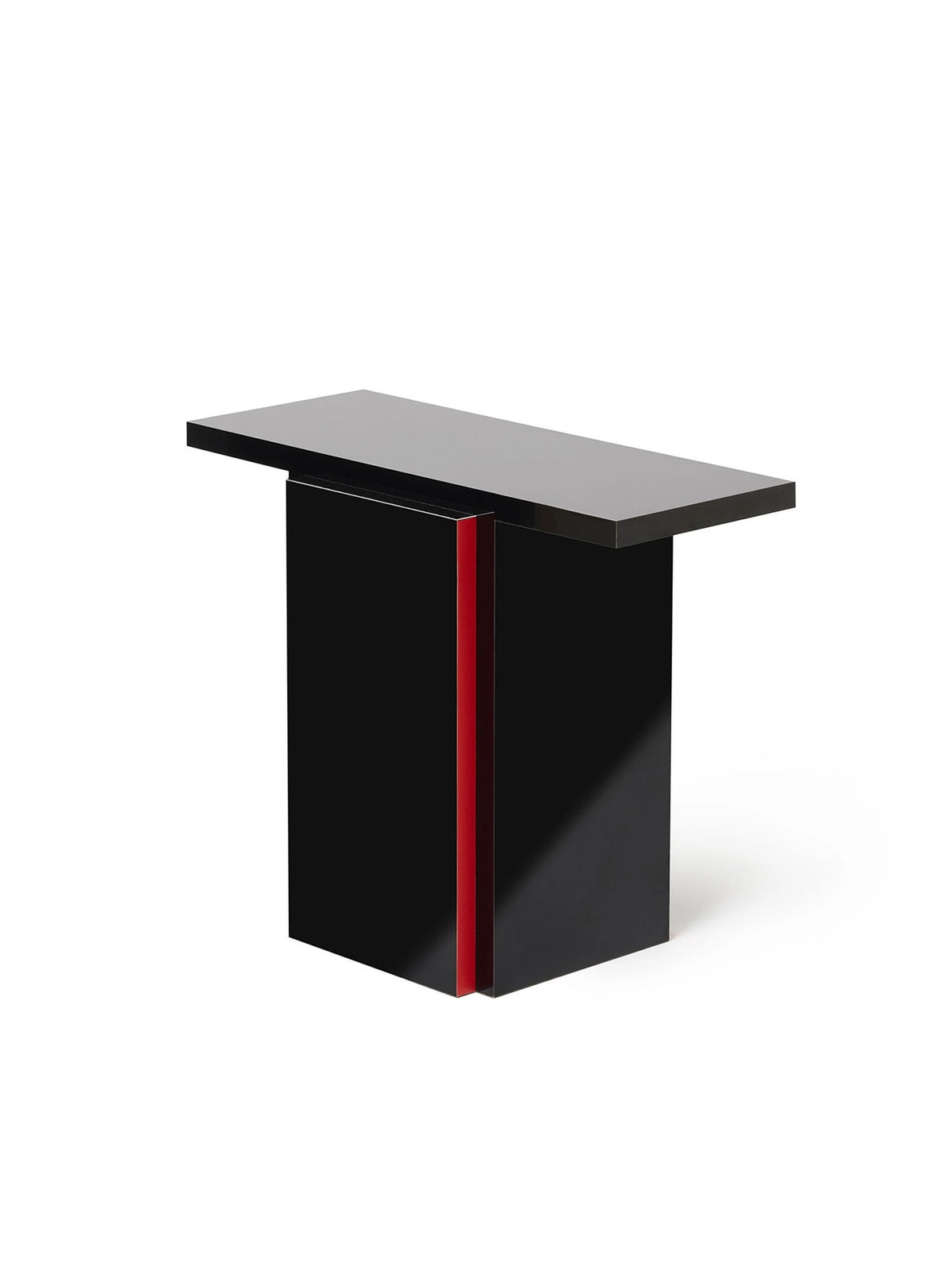 The Mara T Side Table – Red Line by TEGET is a modern, high-gloss black table with a vertical red accent. Its minimalist, geometric design features a flat top and sturdy base, showcasing the elegance of laminated furniture.