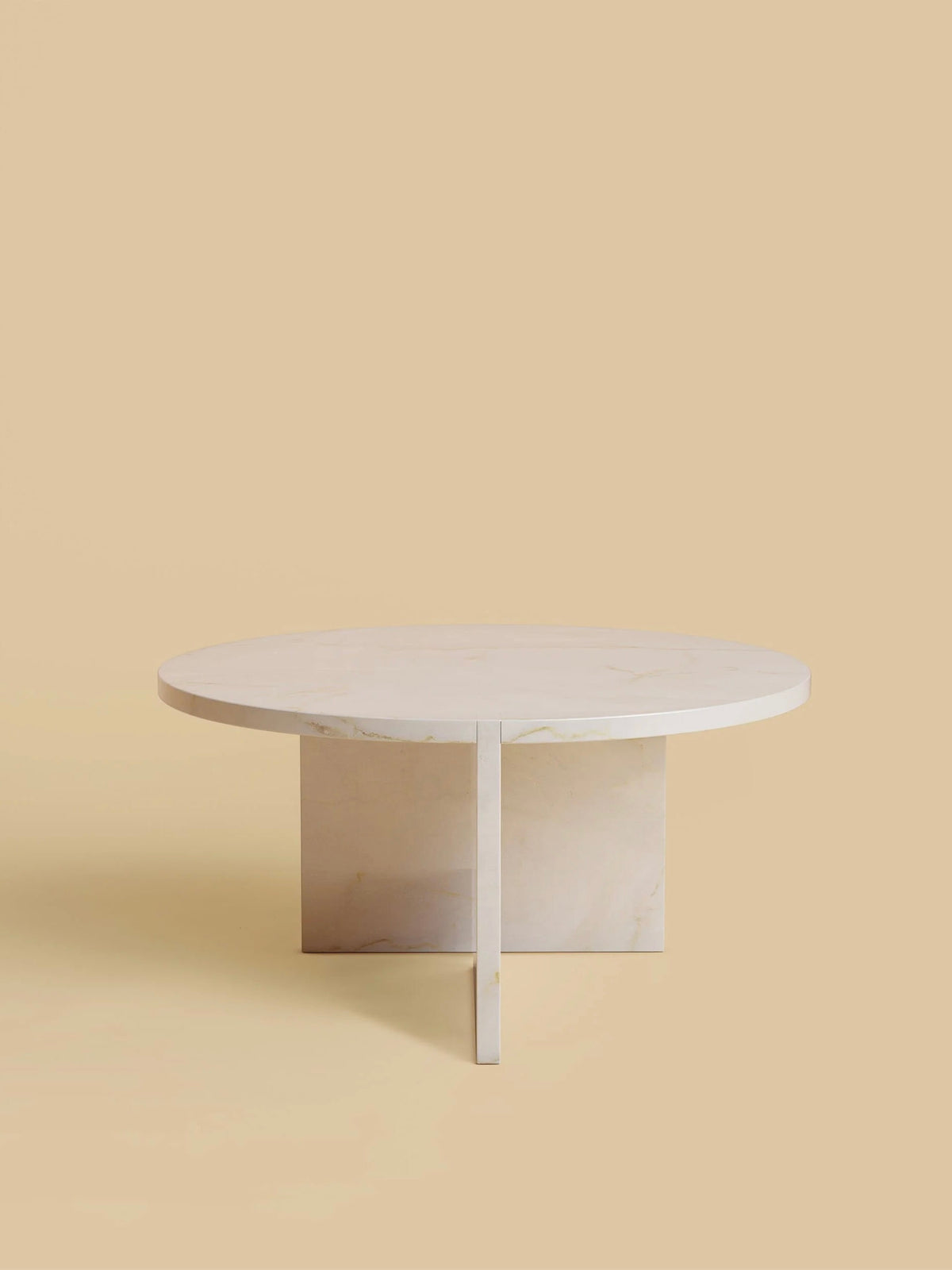 The "Hashi" Coffee Table by Lebanto boasts a minimalist marble design with a smooth surface and a sturdy base featuring two intersecting rectangular panels on a beige background.