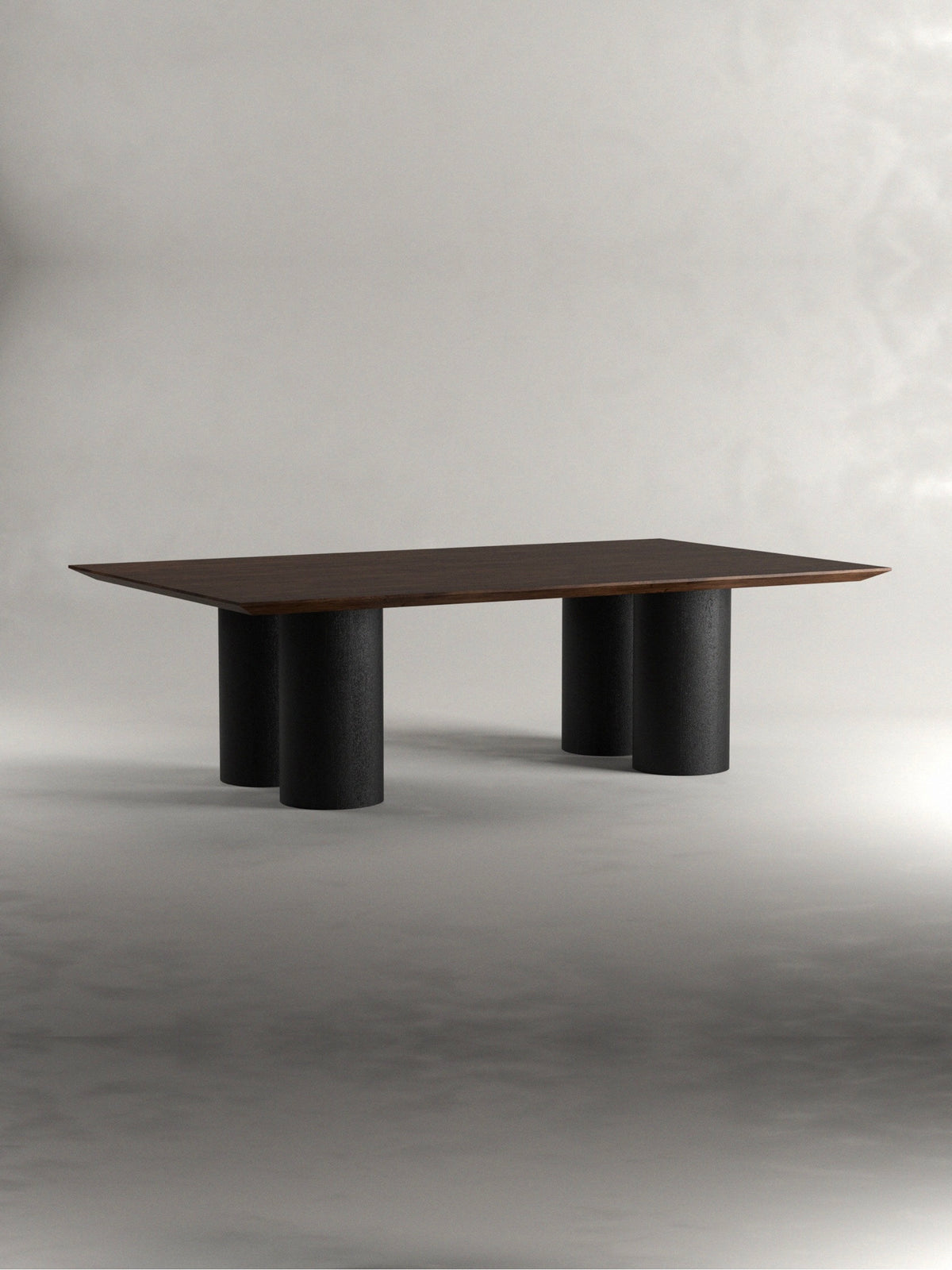 The 'Pier' Dining Table by Siete Studio features a modern rectangular design, a slim walnut tabletop, and four cylindrical black legs, set against a plain gray background.