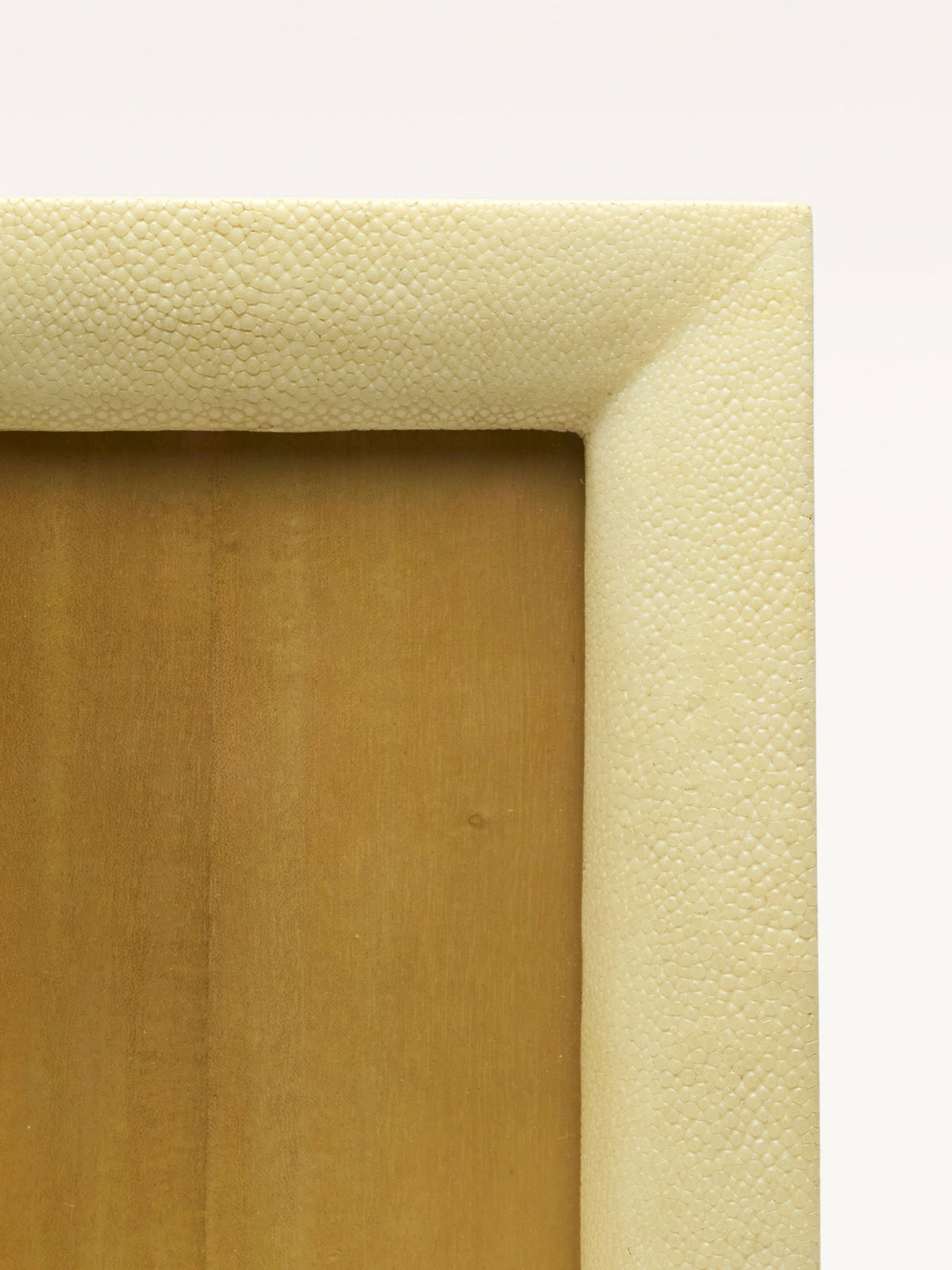 Corner detail of cream shagreen textured frame showing leather finish