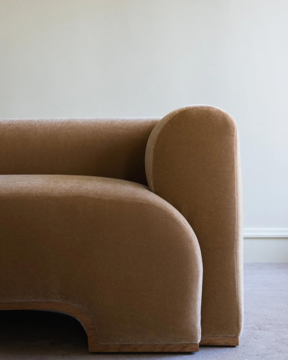 Close-up detail of Quincy sofa's curved arm and plush upholstery