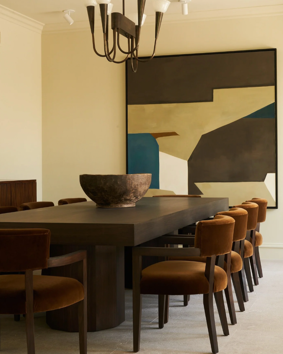 Hillcrest dining chairs in burnt orange velvet around dark table