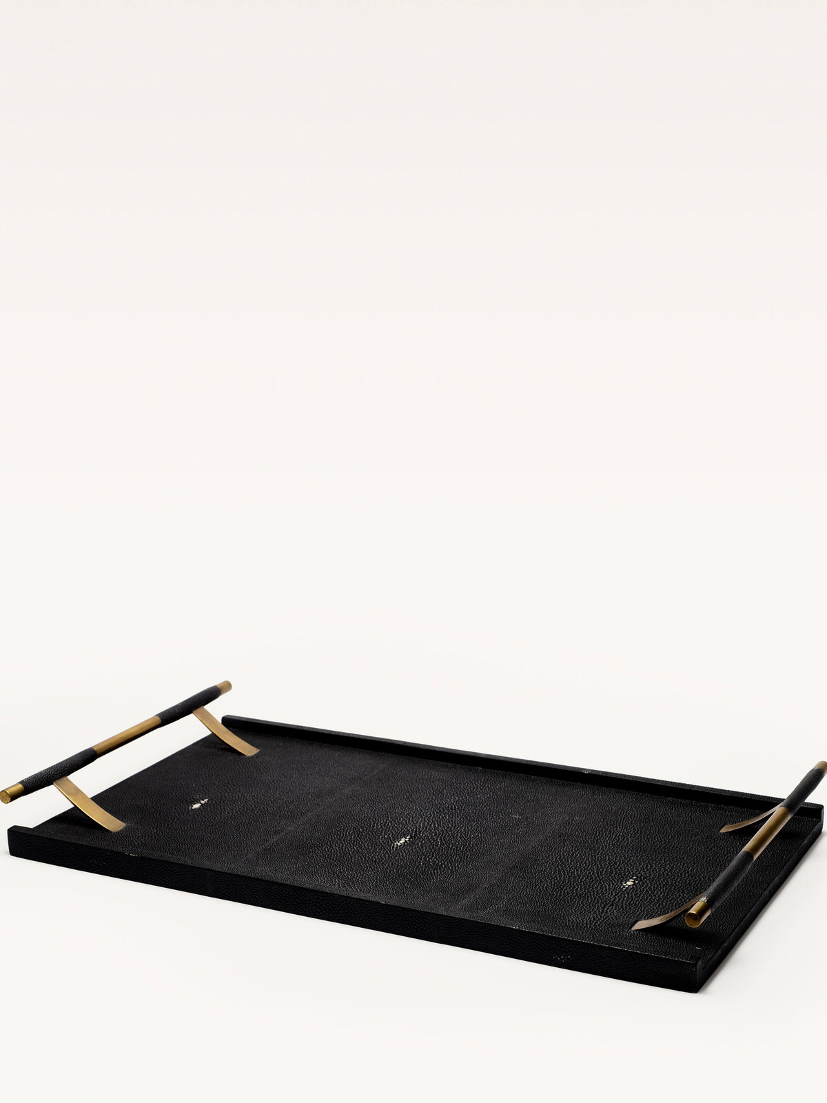 The Galerie MLS Black Shagreen Tray is rectangular with a textured surface and bronze patina brass handles, inspired by R&Y Augousti, shown on a plain white background.