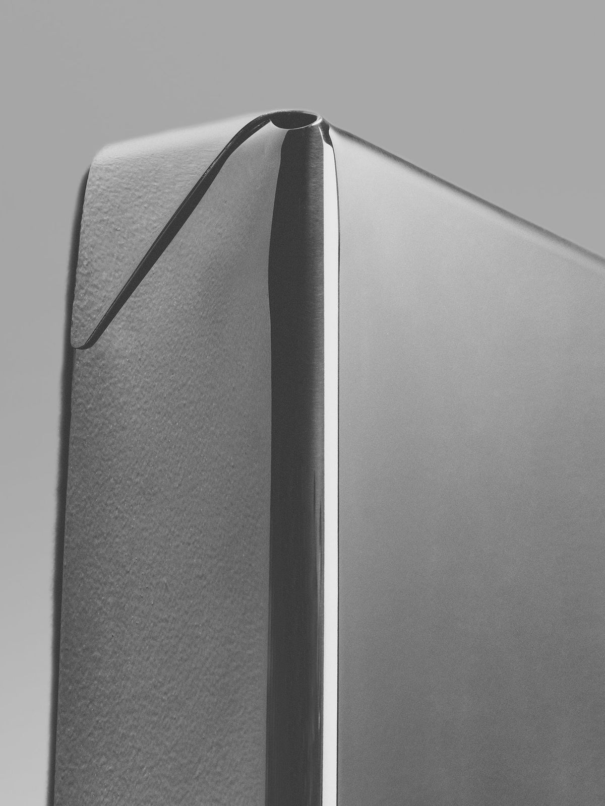 Detail view of Fold Mirror showing curved metallic edge and frame