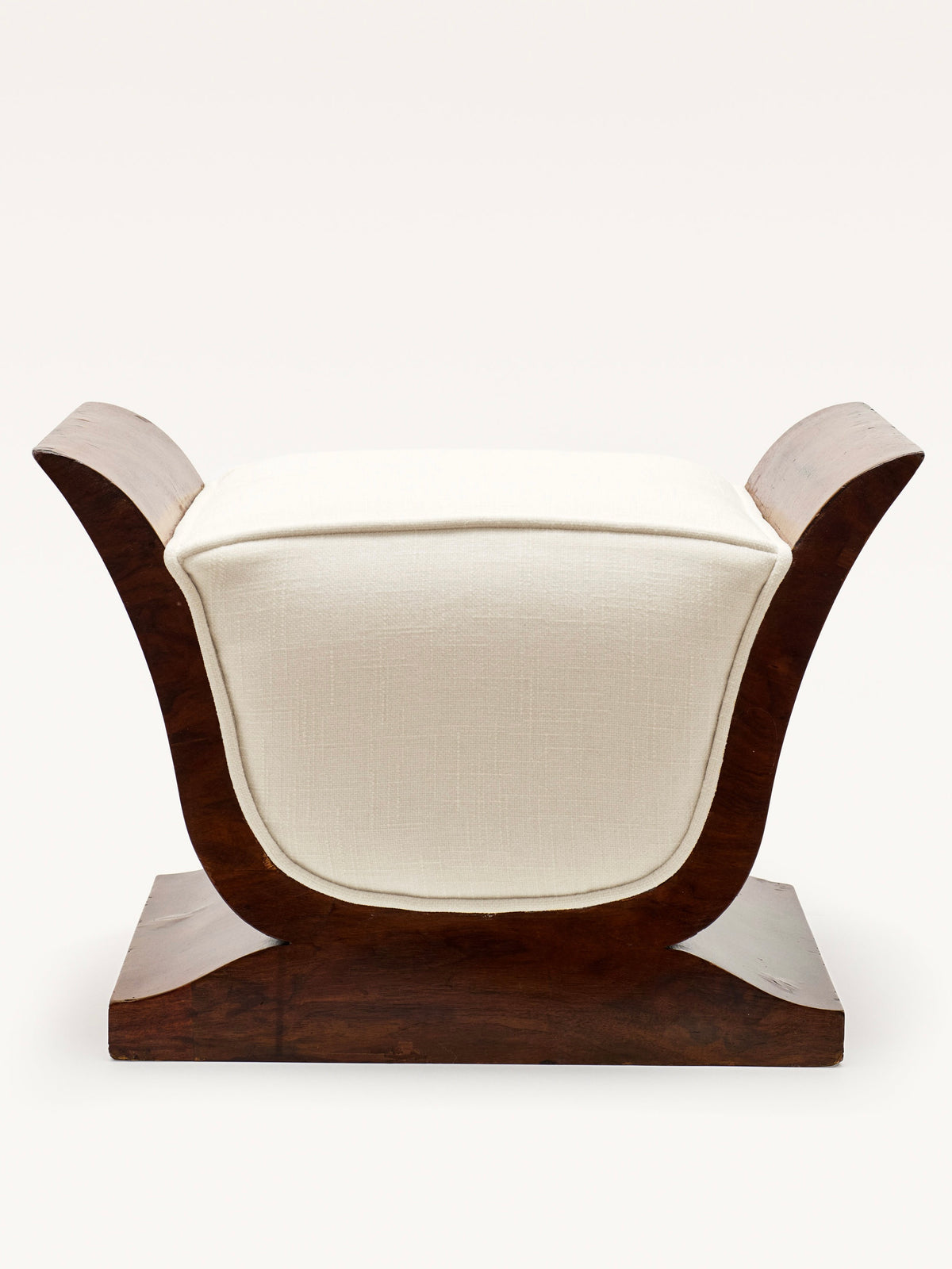 The Art Deco Stool by Galerie MLS features a vintage-inspired lyre shape and walnut design. With a white cushioned seat between upward-curved wooden arms, its dark wooden base contrasts against the light upholstery, creating a stylish modern aesthetic reminiscent of the 1930s.