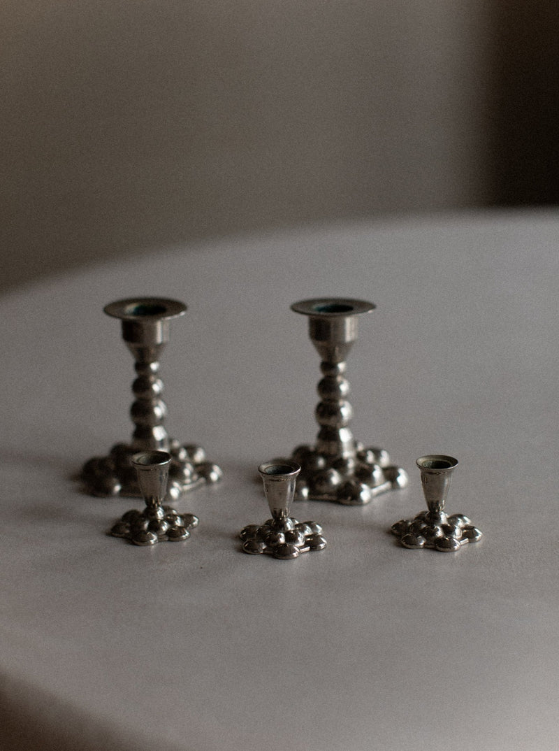 Bubbly Candleholders: Elegant silver candleholders with a bubbly texture and sleek design