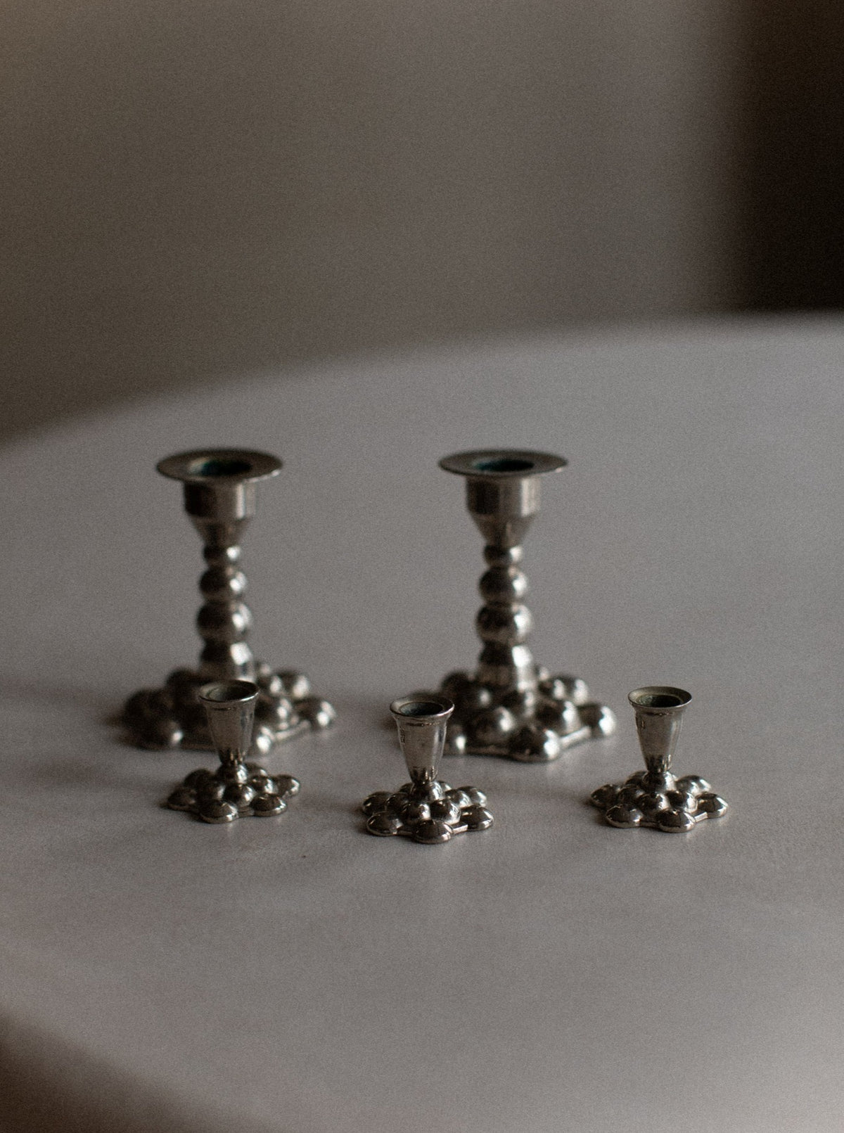 Bubbly Candleholders: Elegant silver candleholders with a bubbly texture and sleek design