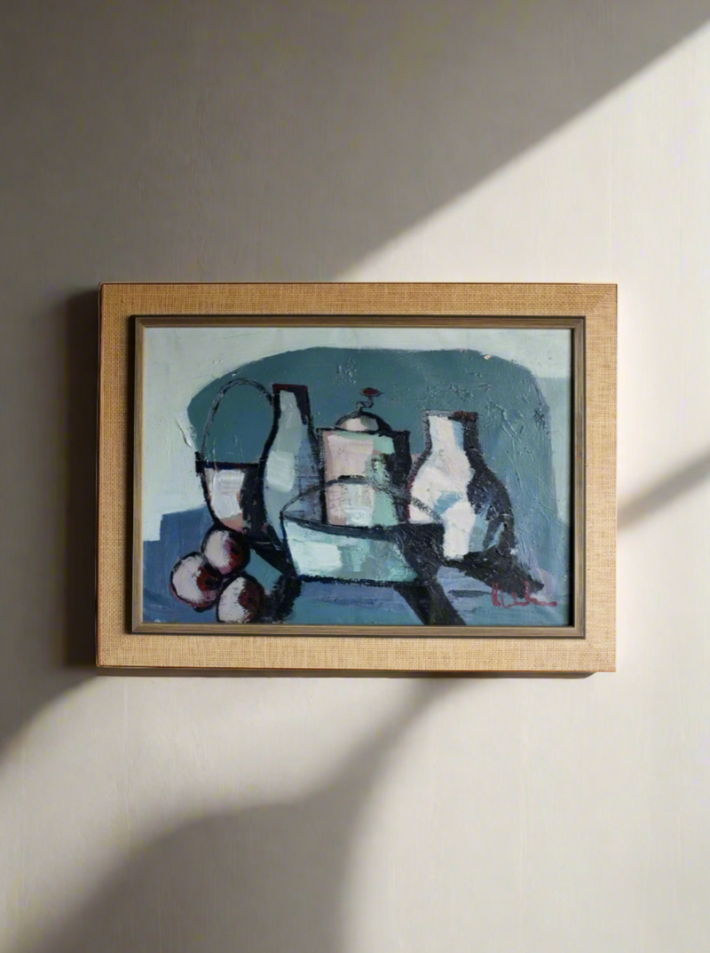 The Veter Vintage Vintage Still Life Painting in Blue Hues | Oil on Canvas is framed and showcases a vintage still life composition. The artwork features various objects, including a pitcher, bowl, and three round fruits, rendered in abstract forms with a predominantly blue color palette. The frame is a light wood tone, reminiscent of European art.