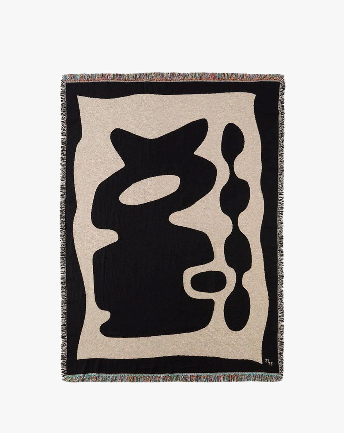 The Kozu Jacquard Throw by 2222Studio features a handcrafted beige background with black abstract shapes, offering a minimalist look. Irregular smooth forms create curves and loops, while multicolored fringed edges add contemporary flair.