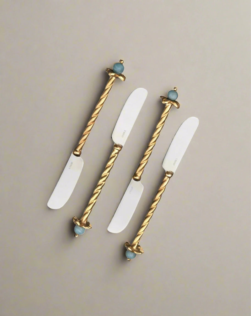 Four Venise Spreaders (Set of 4) with twisted golden handles and bird figurines on the ends, displayed against a white background, expertly crafted by artisans of Venice.