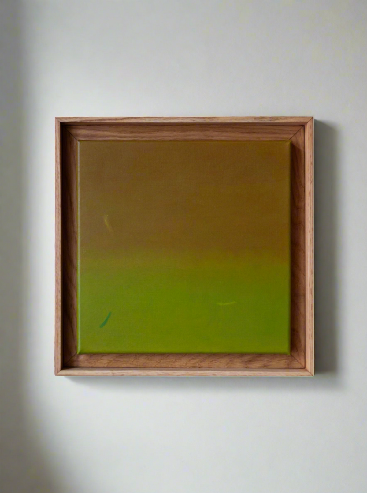 An exclusive masterpiece by Rebecca von Matérn titled "Untitled Acrylic on Canvas, 2024" hangs on the wall. This minimalist acrylic painting in a wooden frame features a gradient transitioning from light brown at the top to a greenish hue at the bottom.