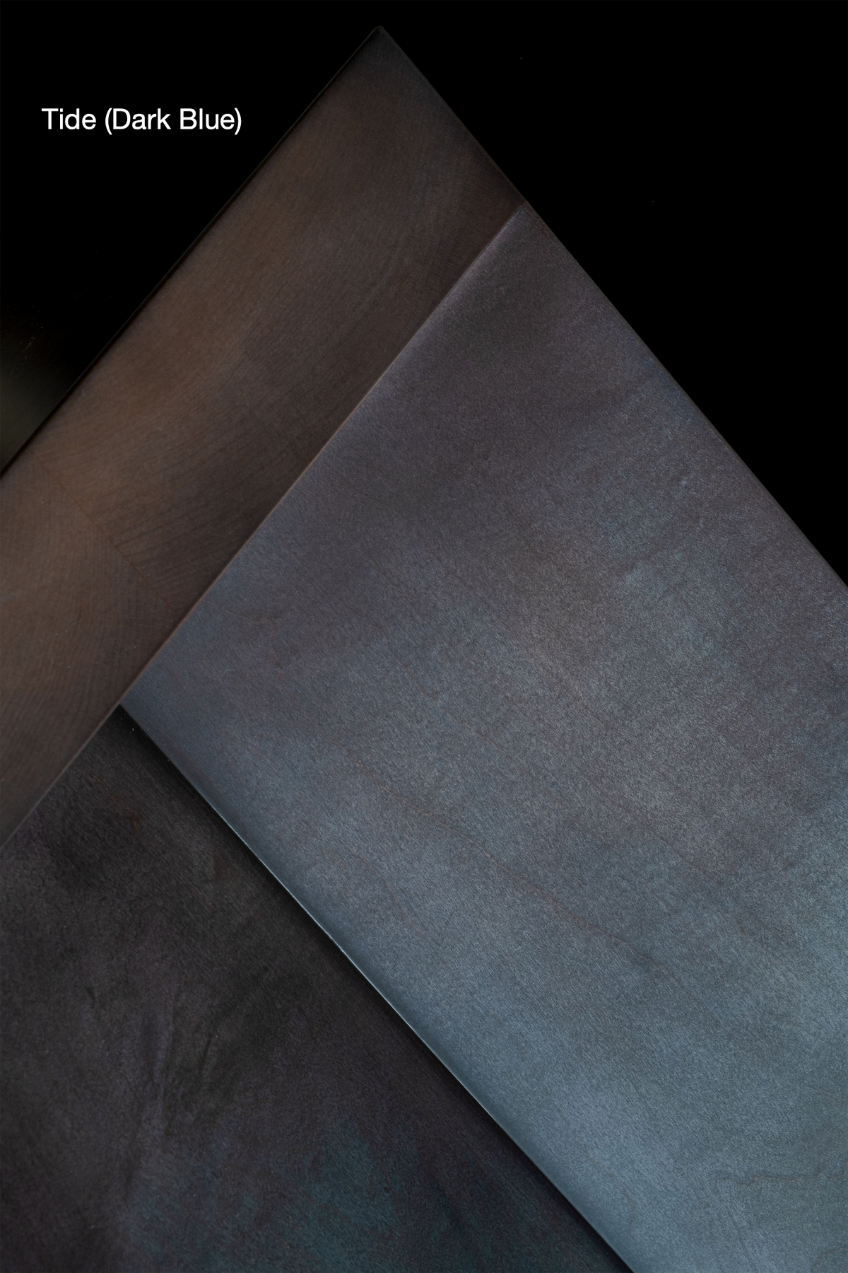 A dark blue gradient background with a soft, brushed texture. Overlapping angular sections create a sense of depth and dimension. The text "Arc Bench" by Juntos Projects is situated in the upper left corner, reminiscent of premium natural materials.