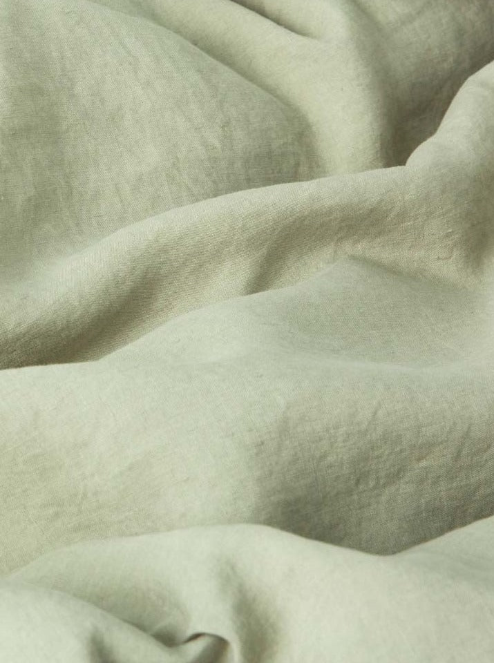 Close-up of textured, wrinkled MOST Washed Linen Bed Set in Sage comforter cover with soft folds, highlighting the detailed weave and subtle color variations.