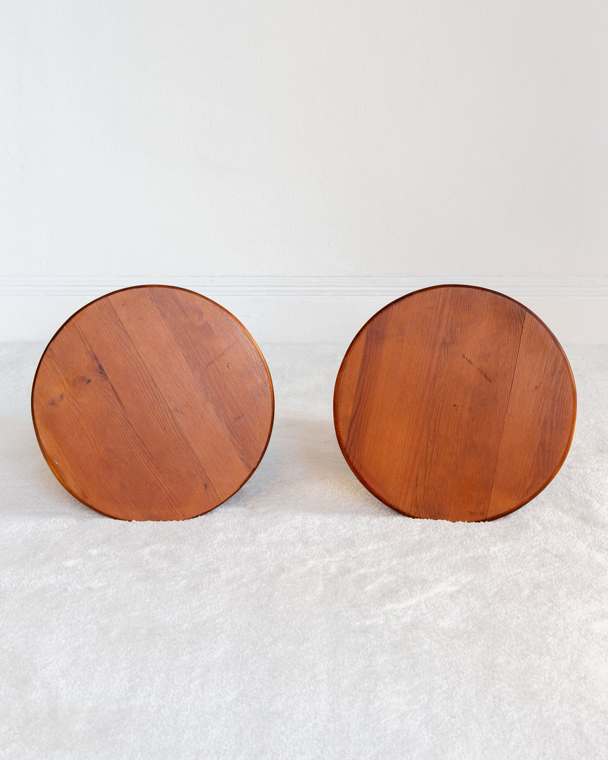Underside view of vintage Swedish pine stools showing wood grain