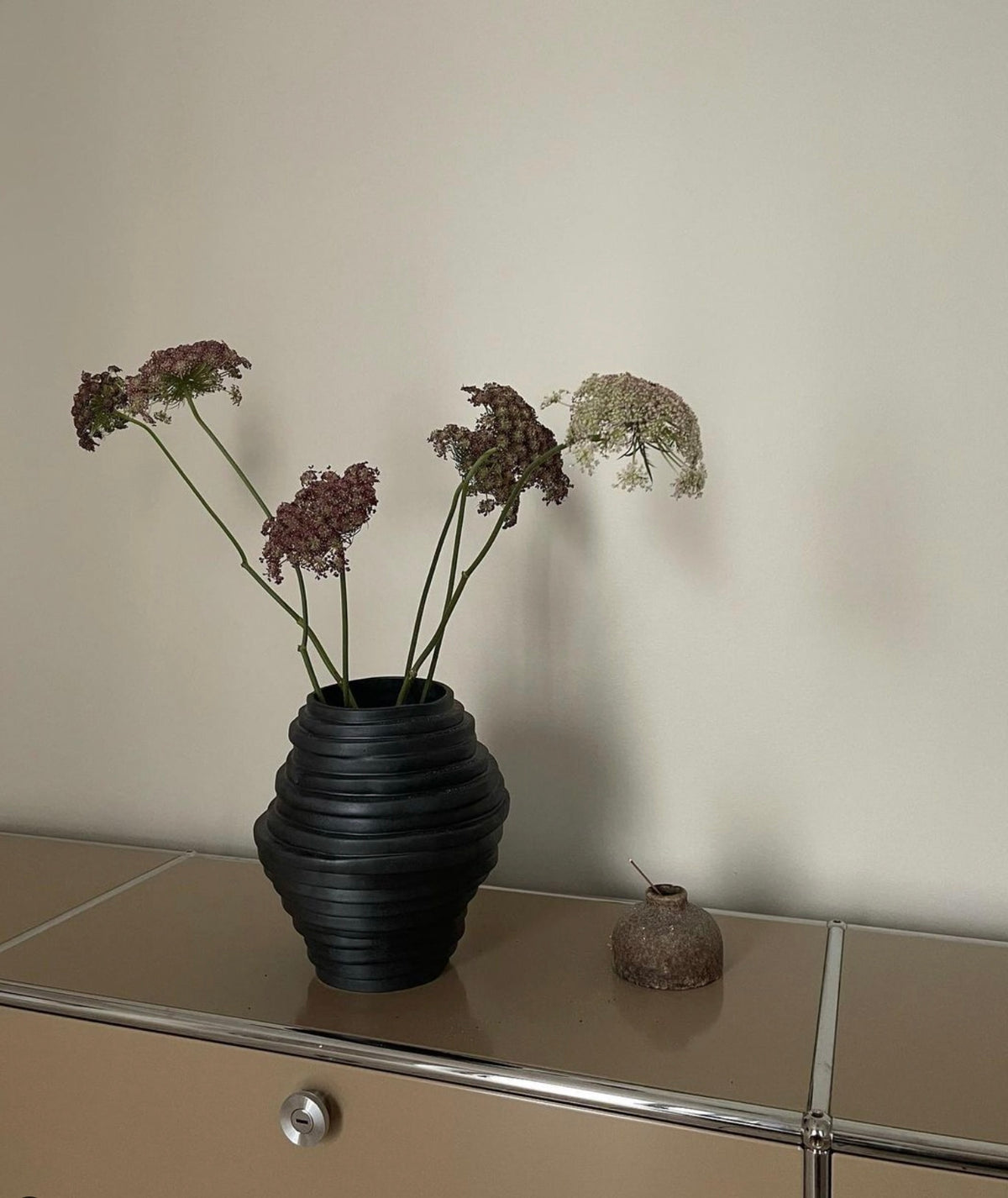 Alfonso Vase Brick — black ceramic vase with dried flowers on sideboard