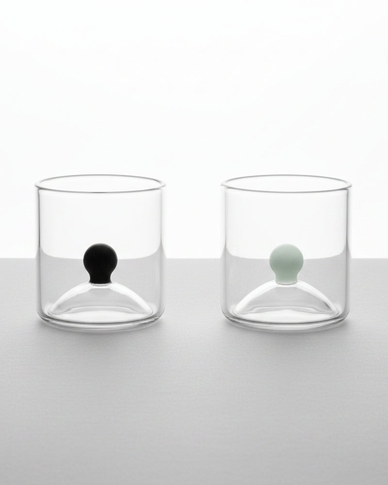 Set of two clear glass shot glasses with black and white sphere details