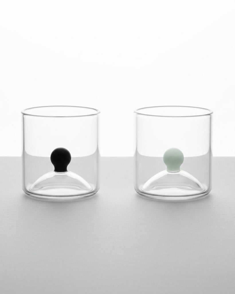Set of two clear glass shot glasses with black and white sphere details