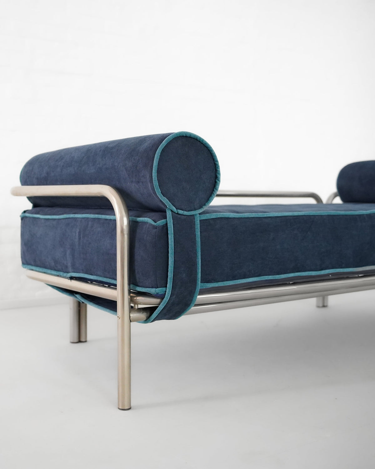 Blue velvet Locus Solus daybed detail showing cylindrical armrest