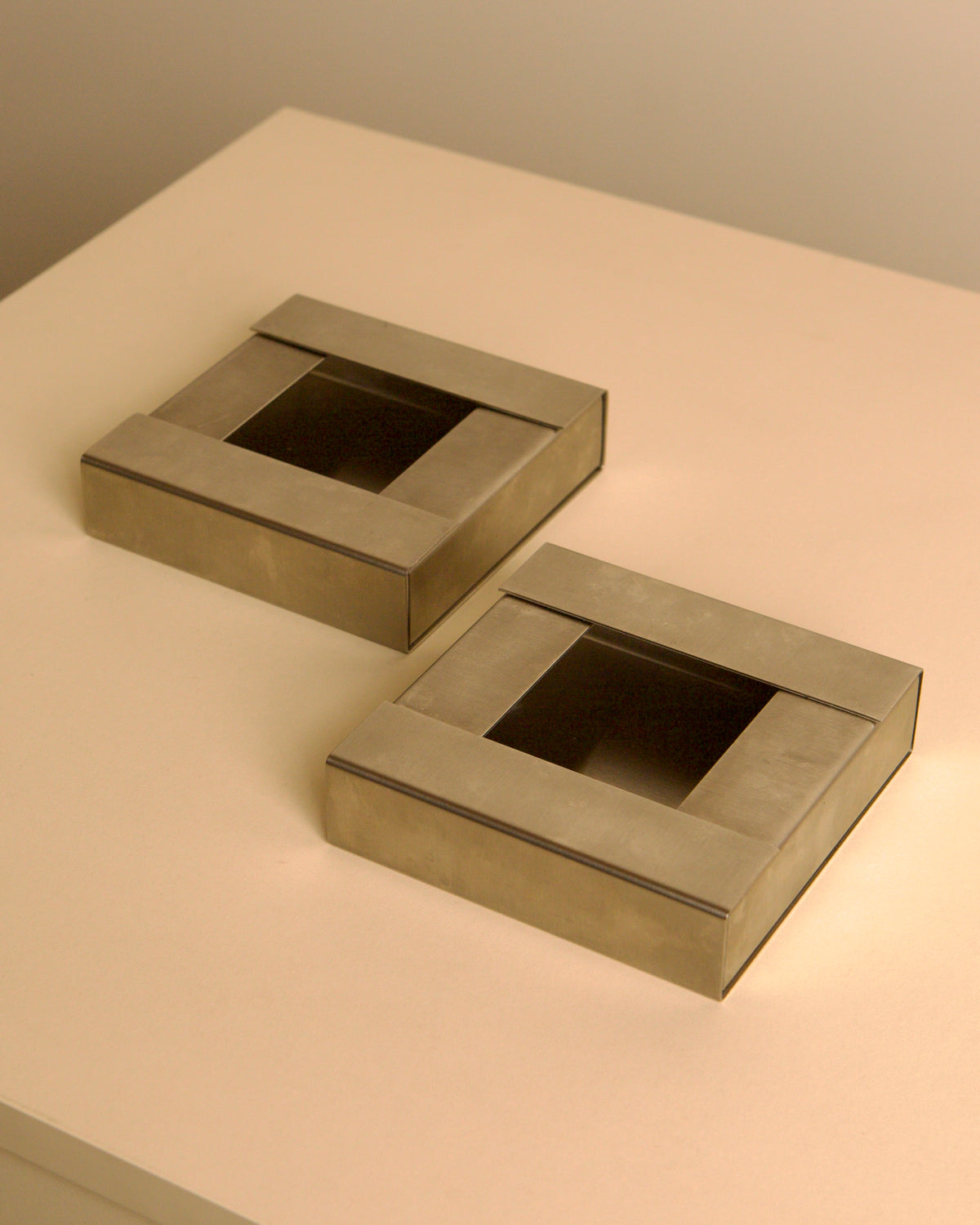 Pair of Italian brushed metal ashtrays by Fontana Arte, 1960s — detail view