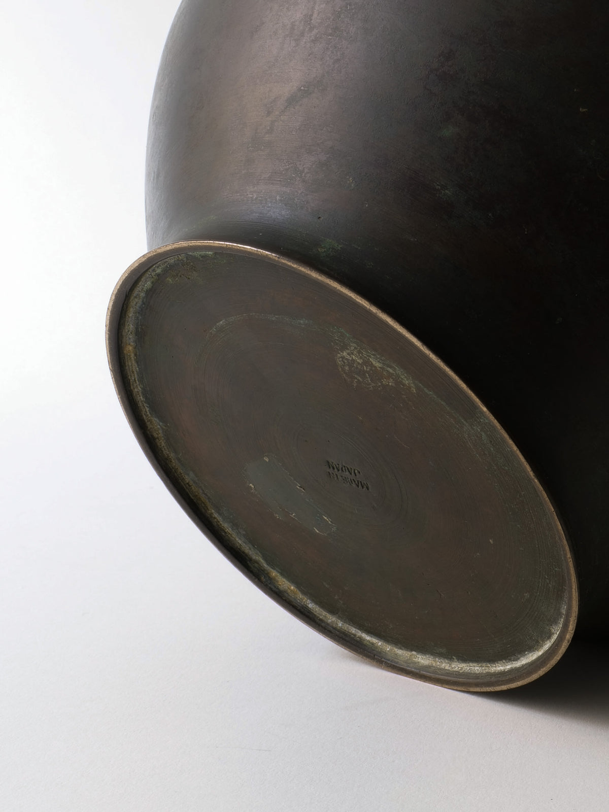 Bottom view of bronze ikebana vase showing interior and rim detail