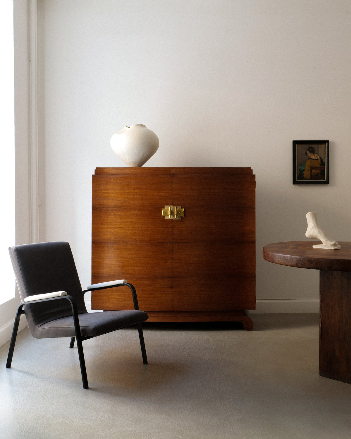 1930s walnut cabinet by Jules Leleu in modern interior setting