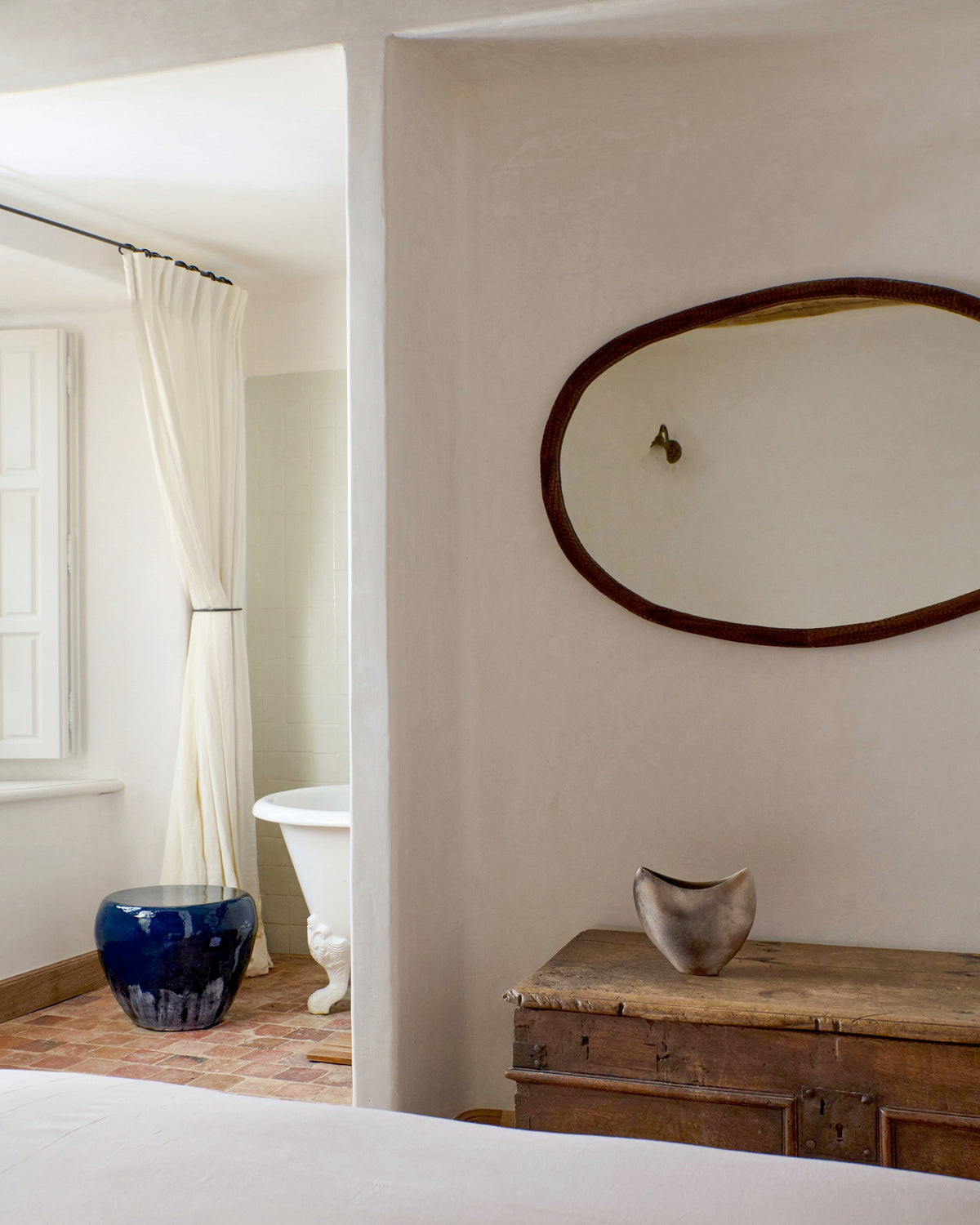 Medium Ceramic Side Table — positioned beside vintage wooden chest in bright room