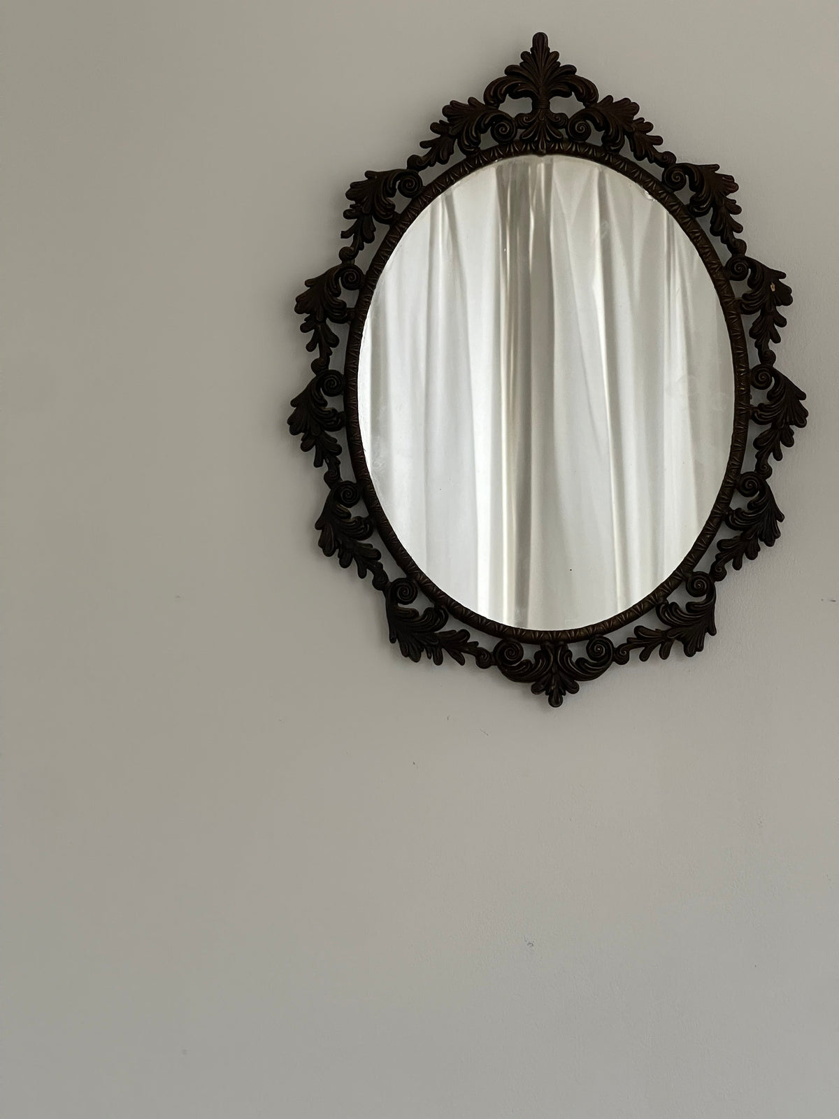 Ornate Vintage Oval Mirror, Rococo Frame — close-up of dark wood frame