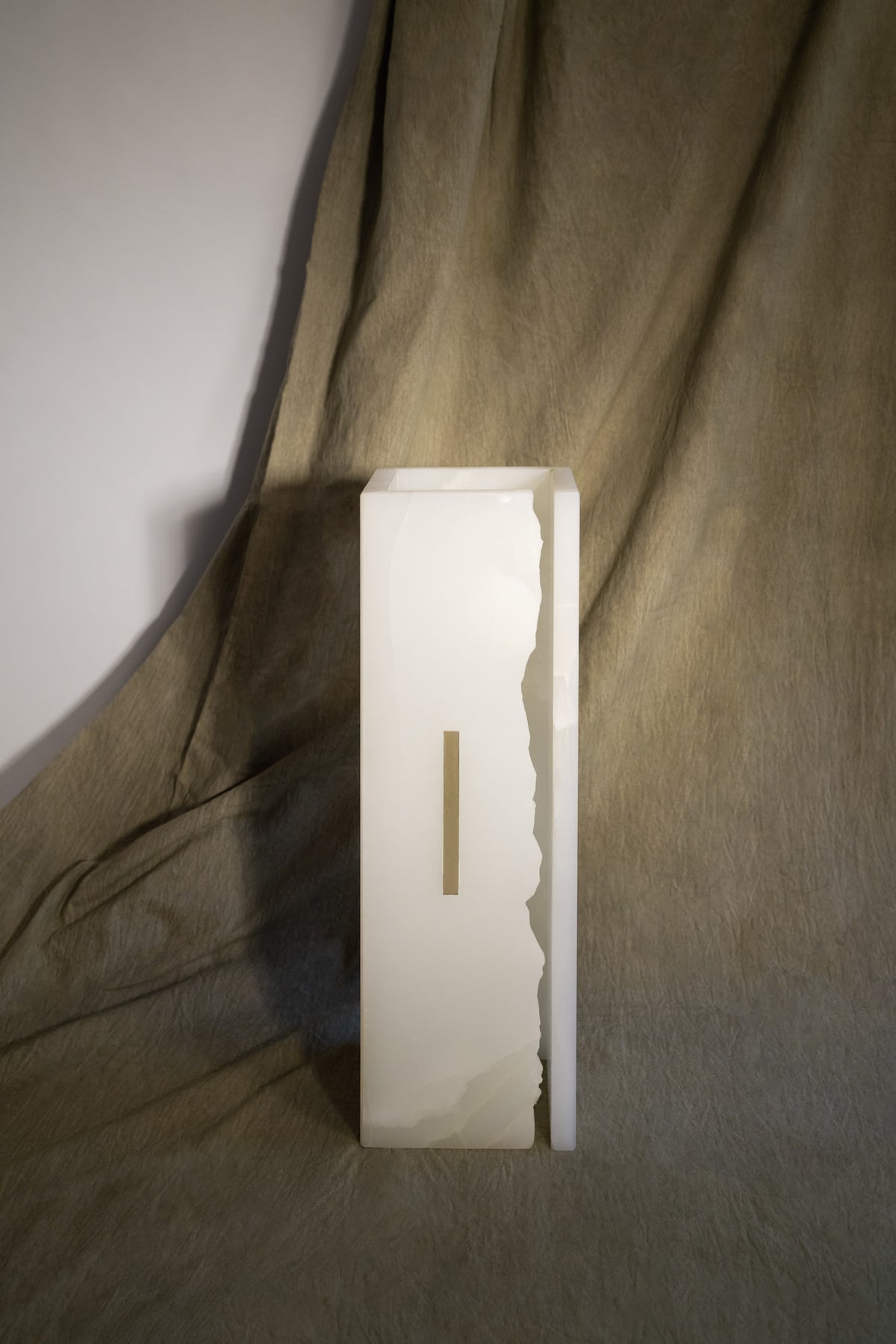03C PURE WHITE ONIX Collectible Lighting in stone — angled view against textured backdrop