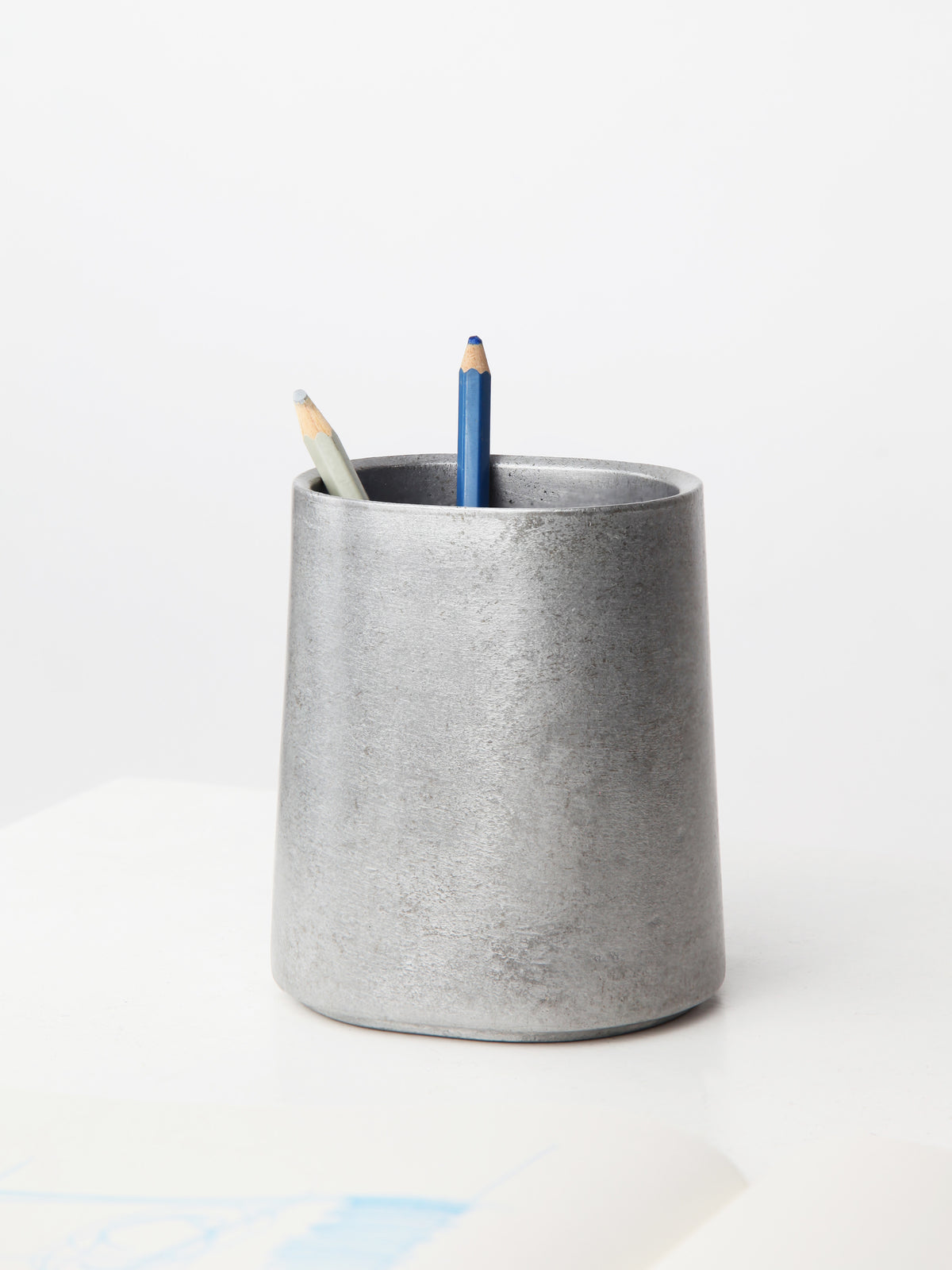 Taper Pen Stand — back view of gray concrete holder with pencils