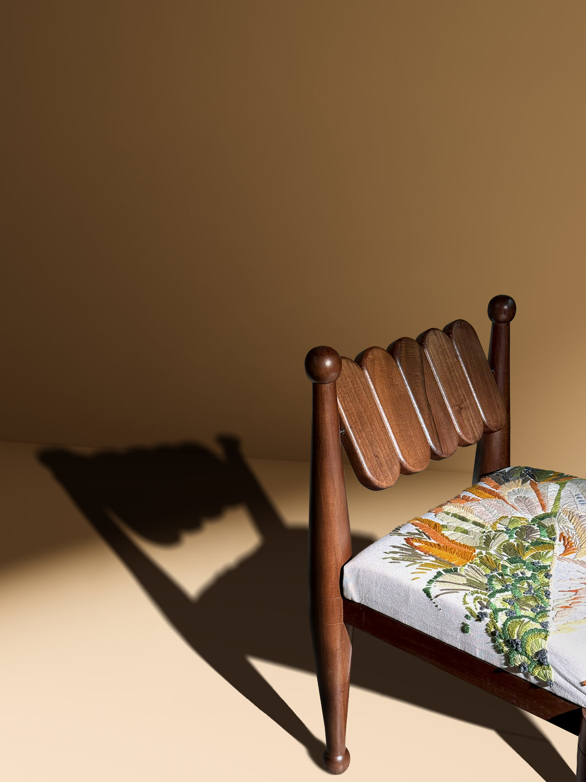 SIMORGH II – Solid Walnut with Hand-Embroidered Upholstery — side angle showing detailed upholstery and wooden structure