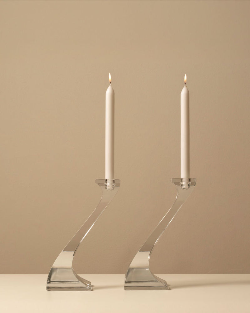 Pair of Riedel Duetto crystal candleholders with lit white candles