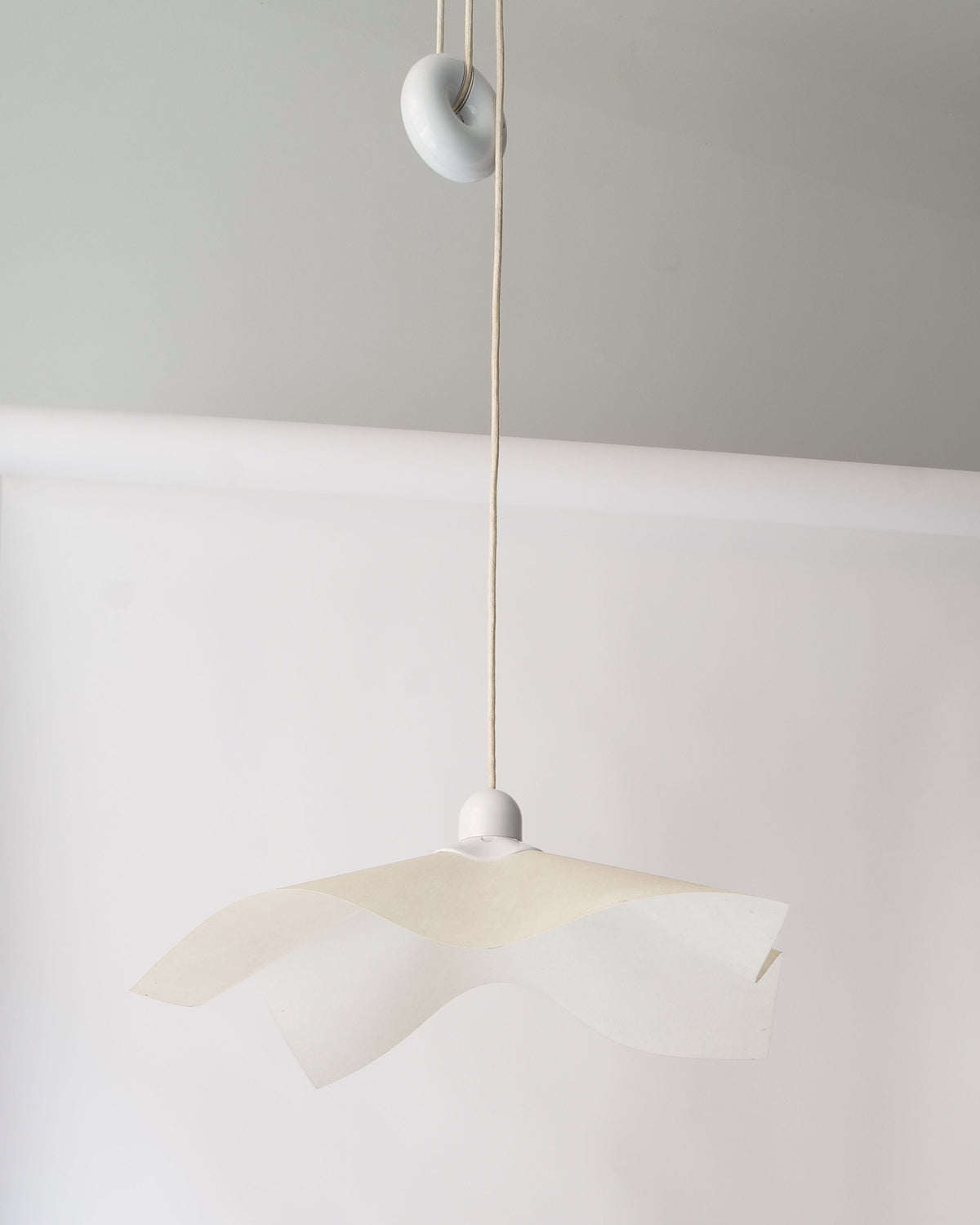 Adjustable Ceiling Lamp Mario Bellini 1970 — hanging in minimalist setting with white backdrop