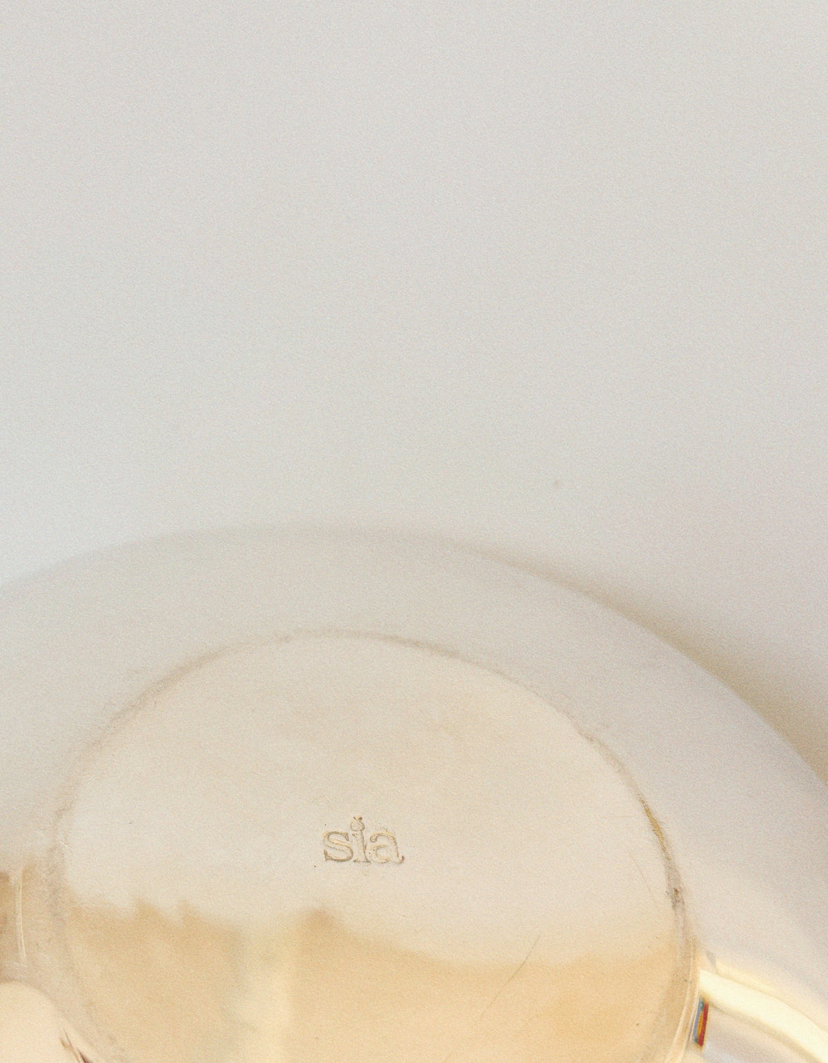 Close-up detail of silver plated teapot showing maker's mark