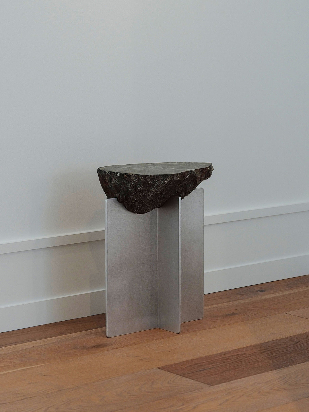 Hybrid Objects' Side Table — side angle showing natural stone top and metal base