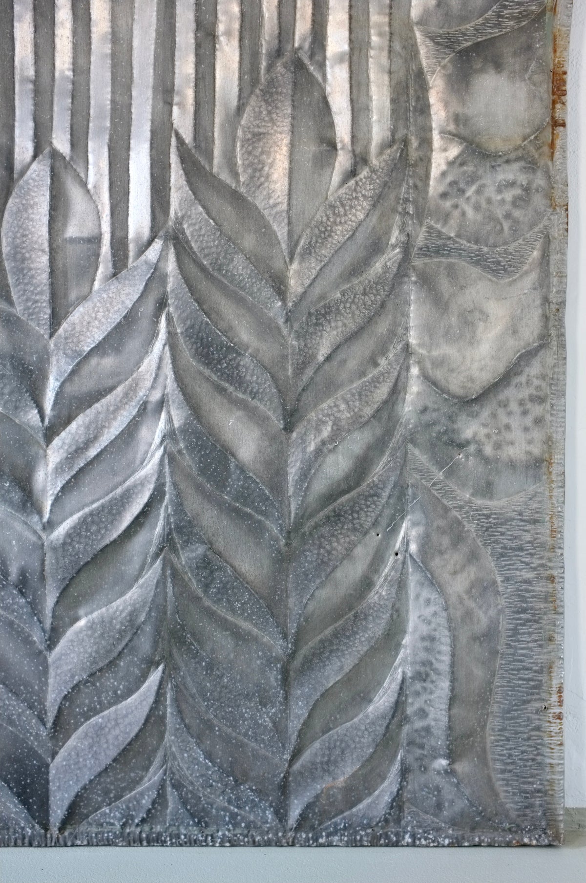 Brutalist metal relief sculpture with geometric leaf and wheat motifs