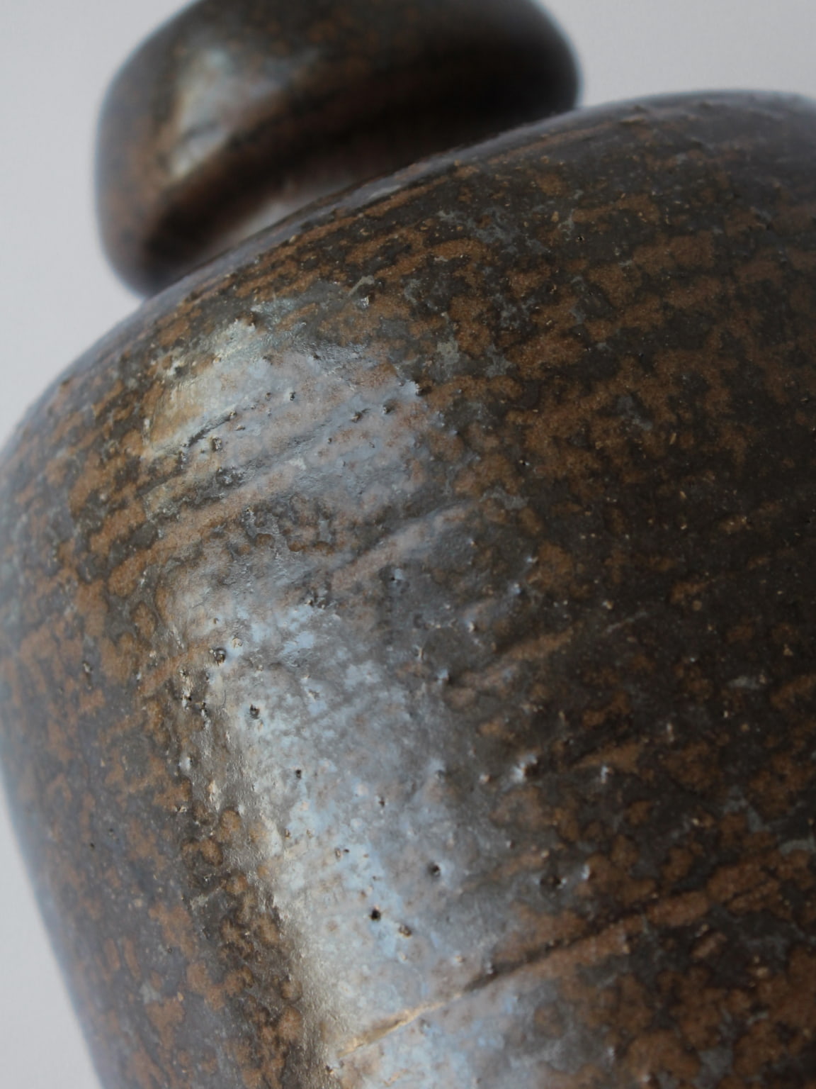 Close-up detail of Rudi Stahl ceramic vase showing speckled glaze
